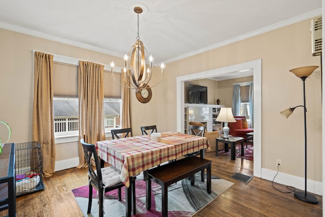 dining room with a notable chandelier, wood-type flooring, and crown molding