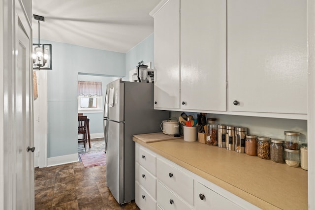 kitchen with white cabinetry, a chandelier, and decorative light fixtures