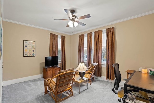 office space with crown molding, ceiling fan, and light colored carpet