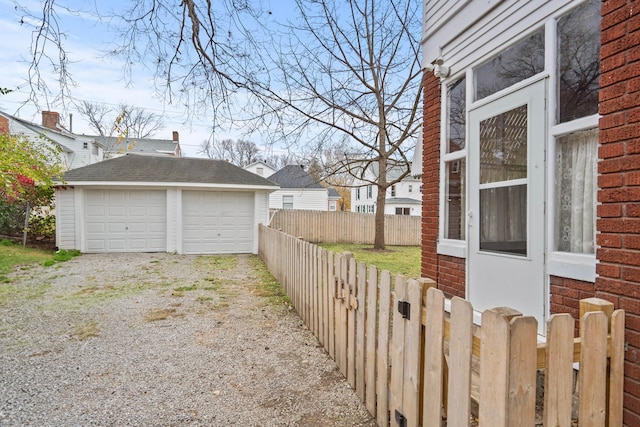 exterior space with a garage and an outbuilding