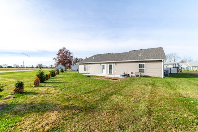 back of property with a patio area and a yard