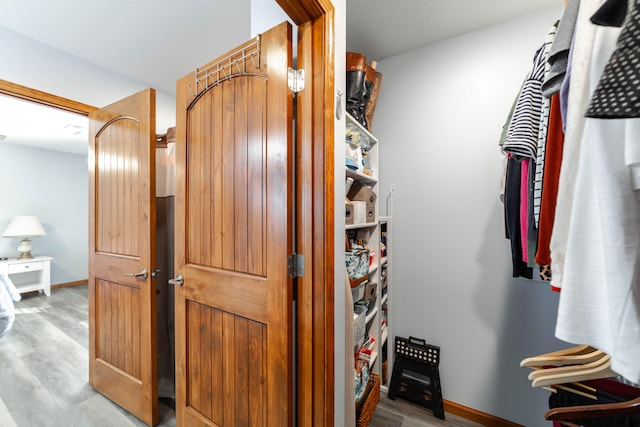 spacious closet with light hardwood / wood-style flooring