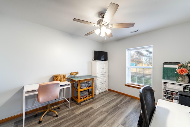 home office with wood-type flooring and ceiling fan