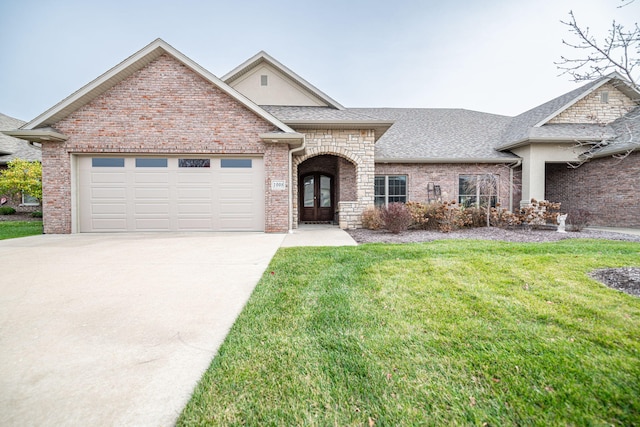 view of front of home with a garage and a front yard