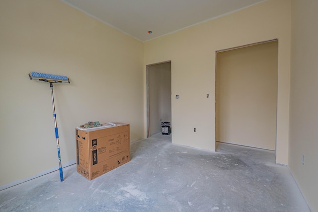 unfurnished bedroom featuring concrete flooring