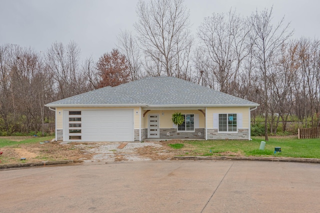 view of front facade with a garage and a front lawn