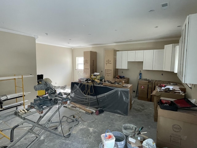 kitchen featuring visible vents, white cabinets, and ornamental molding