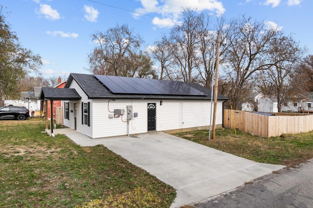 exterior space featuring solar panels and a yard