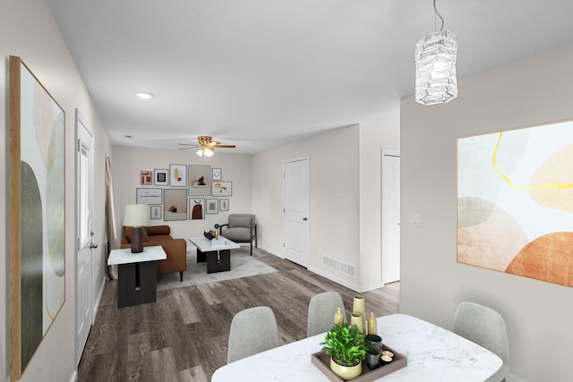 dining area featuring ceiling fan and dark wood-type flooring