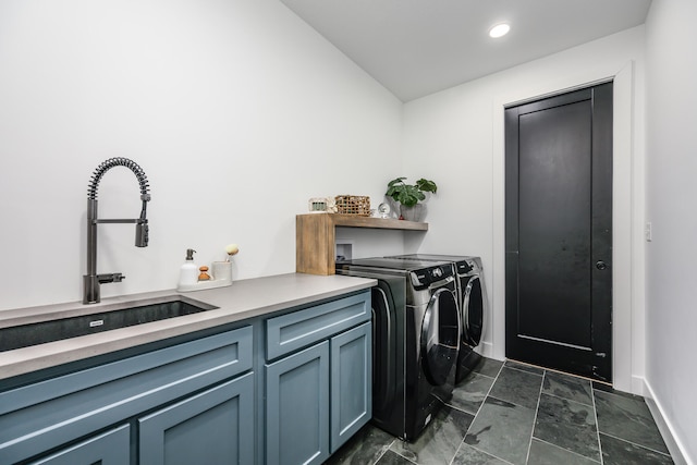 washroom featuring cabinets, washer and clothes dryer, and sink