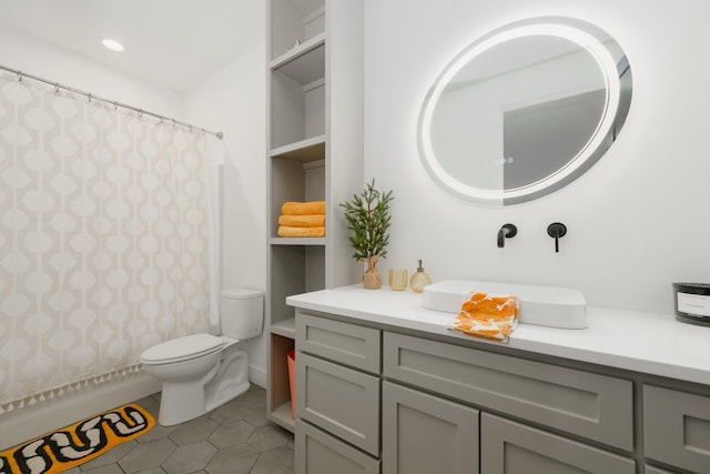 bathroom with tile patterned flooring, vanity, toilet, and built in features