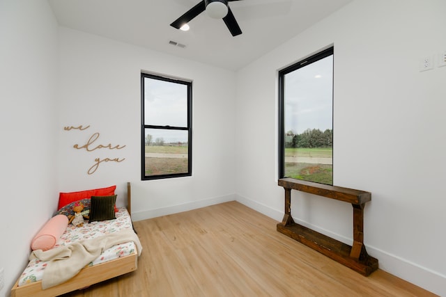 sitting room featuring hardwood / wood-style flooring and ceiling fan