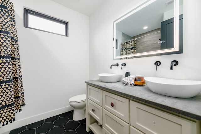 bathroom featuring tile patterned floors, vanity, toilet, and a shower with curtain