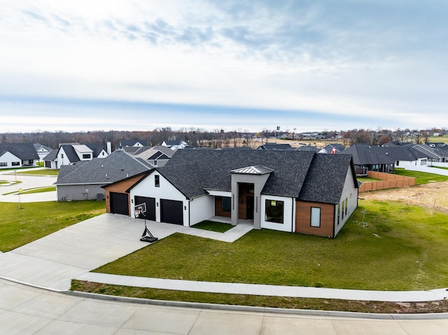 view of front of home with a front yard and a garage