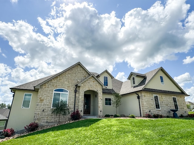 french provincial home featuring a front yard