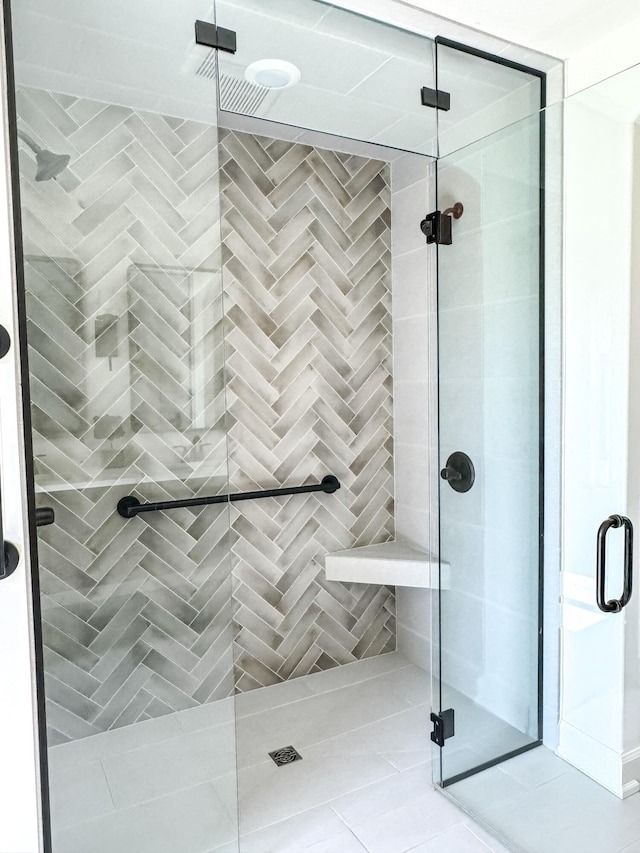 bathroom featuring tile patterned floors and a shower with shower door