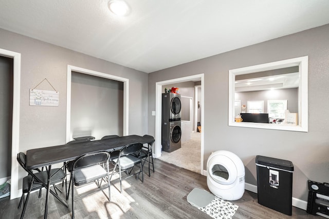 dining room featuring stacked washer and dryer and hardwood / wood-style floors