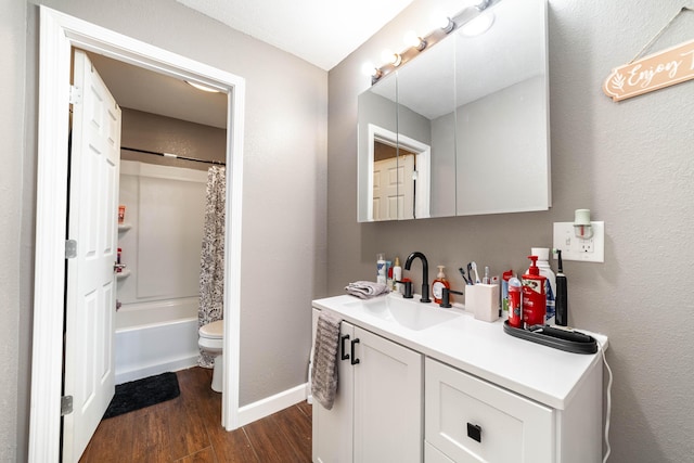 full bathroom with shower / bath combo, vanity, hardwood / wood-style flooring, and toilet