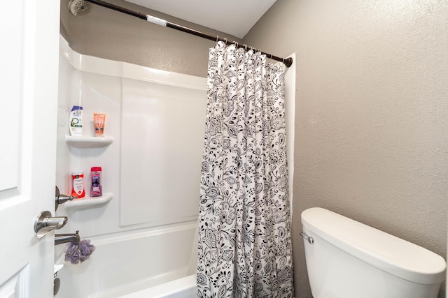 bathroom featuring toilet and shower / bath combo with shower curtain