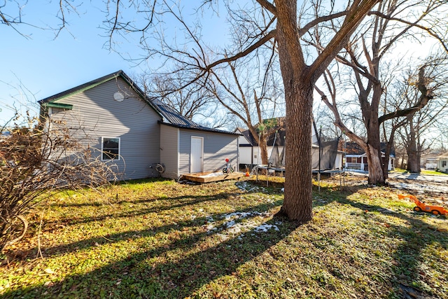 view of yard with a deck and a trampoline