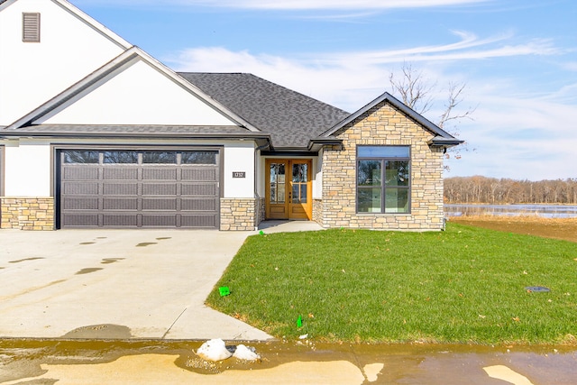 view of front facade with french doors, a front lawn, and a garage