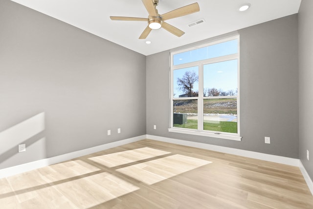 spare room with ceiling fan and wood-type flooring