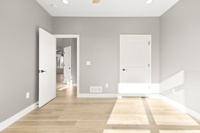 empty room featuring ceiling fan and light hardwood / wood-style flooring