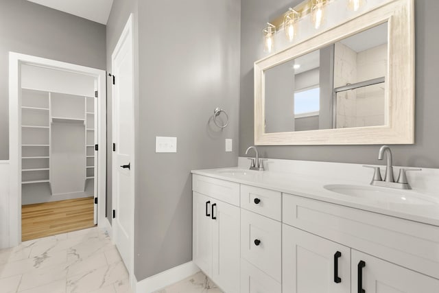 bathroom with a shower with door, vanity, and wood-type flooring