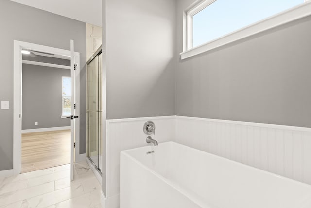 bathroom featuring separate shower and tub and plenty of natural light