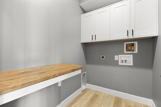 laundry room with cabinets, hookup for a washing machine, light wood-type flooring, and electric dryer hookup