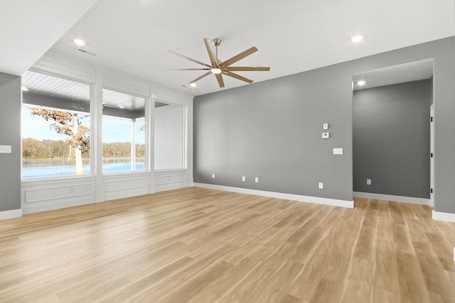 empty room featuring ceiling fan and light hardwood / wood-style floors