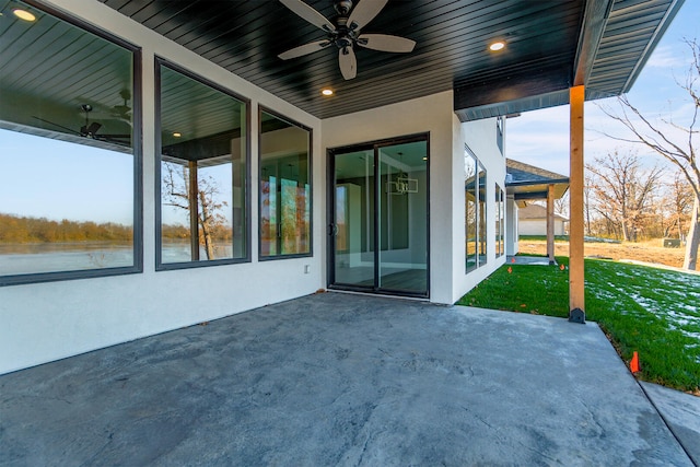 view of patio / terrace featuring a water view and ceiling fan