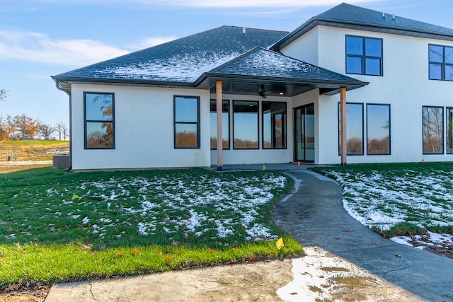 back of property with a lawn and ceiling fan