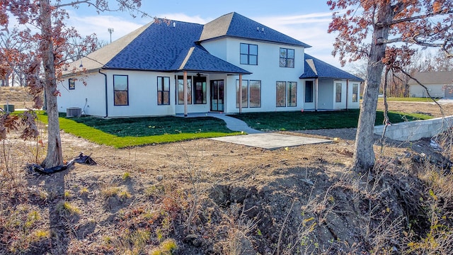 back of property featuring a lawn and central AC unit