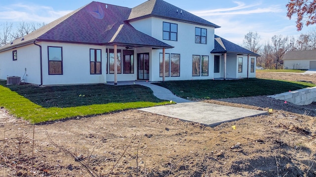 view of front of home with cooling unit, a patio area, and a front yard