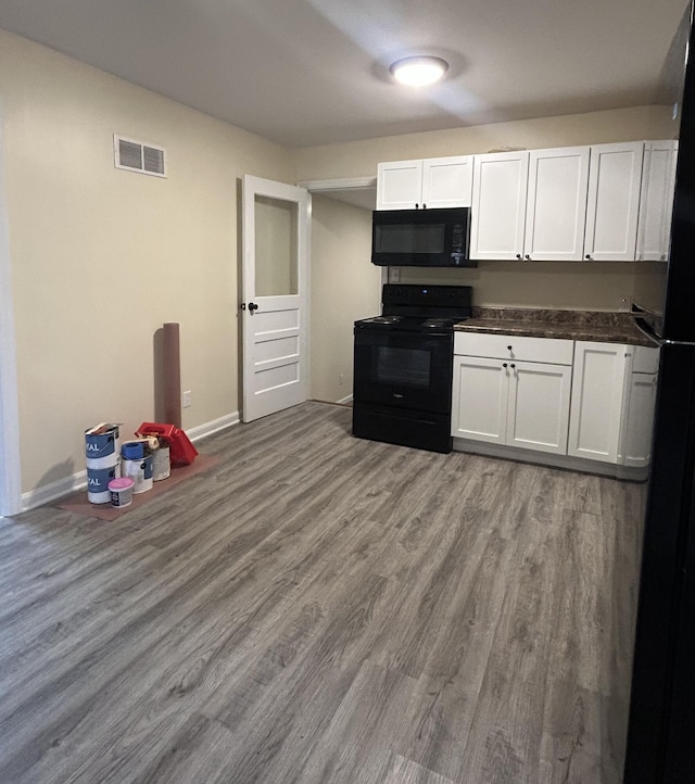 kitchen featuring white cabinets, black appliances, and light wood-type flooring