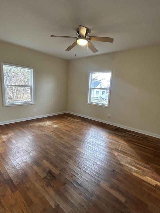 unfurnished room with dark hardwood / wood-style floors and ceiling fan