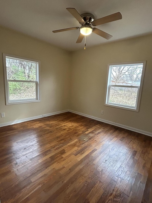 unfurnished room with ceiling fan, a healthy amount of sunlight, and dark hardwood / wood-style floors