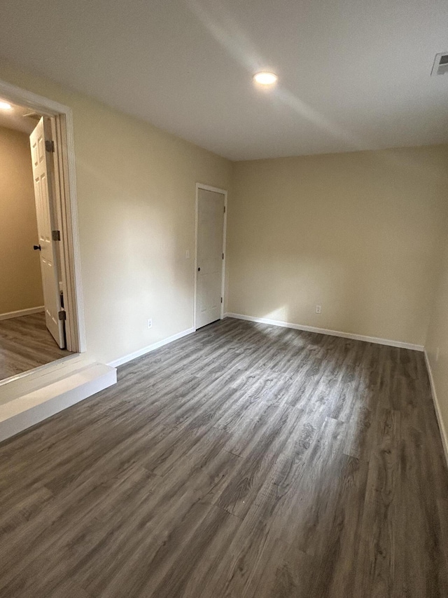 empty room featuring dark wood-type flooring