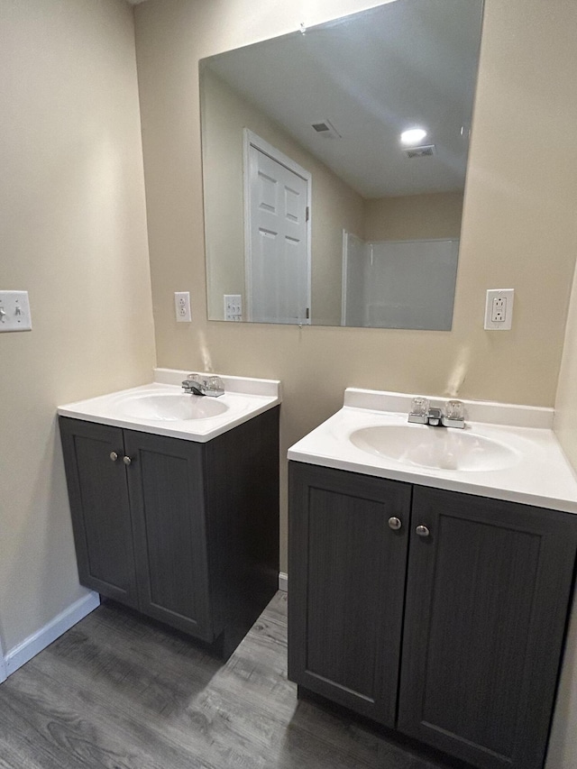 bathroom with hardwood / wood-style floors and vanity