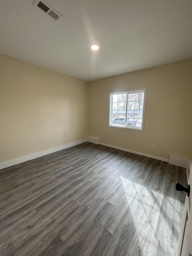 unfurnished room featuring dark hardwood / wood-style flooring