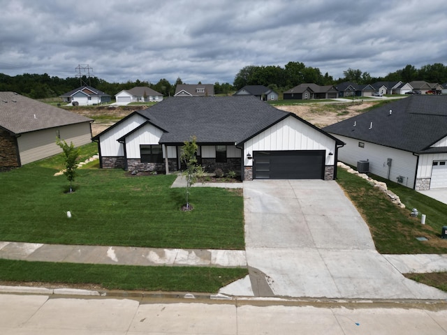 modern farmhouse style home with central AC unit, a garage, and a front lawn