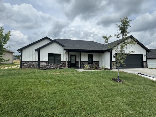 view of front of home with a garage and a front lawn