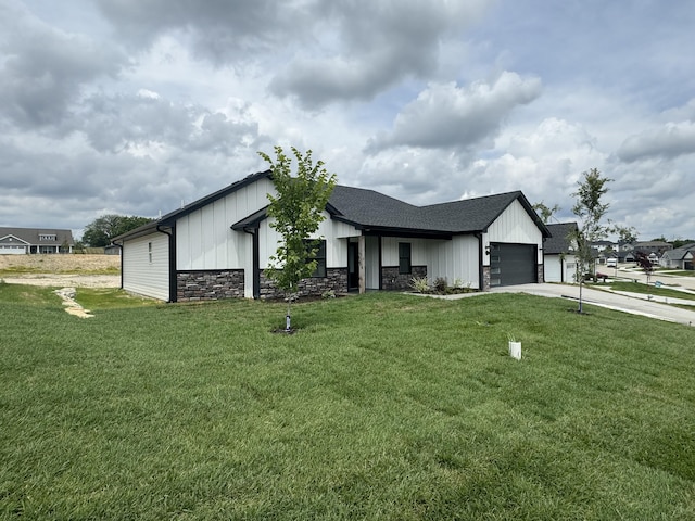 modern farmhouse style home with a front yard and a garage