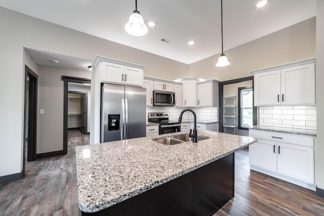 kitchen featuring dark wood-type flooring, white cabinets, sink, appliances with stainless steel finishes, and decorative light fixtures