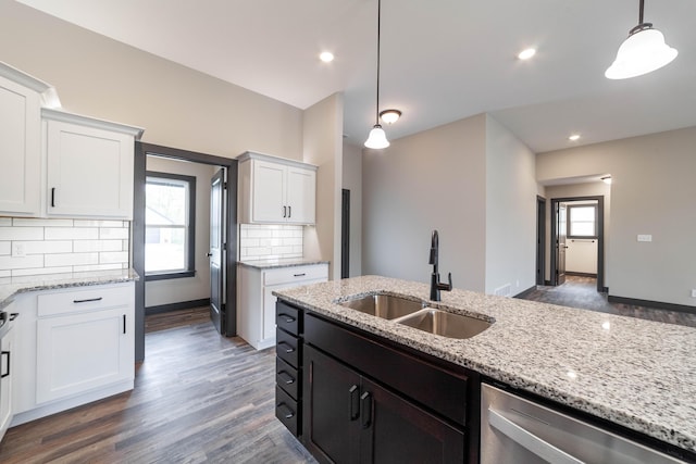 kitchen featuring decorative light fixtures, white cabinetry, plenty of natural light, and sink