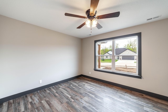 unfurnished room featuring a textured ceiling, ceiling fan, and dark wood-type flooring