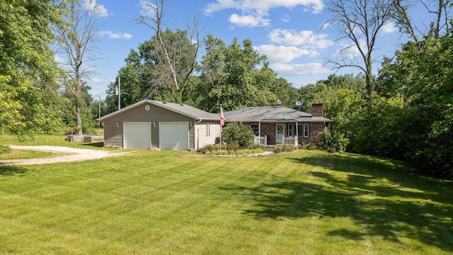 single story home with covered porch, a front yard, and a garage