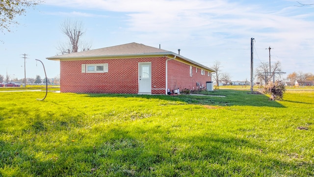 view of side of home featuring a lawn