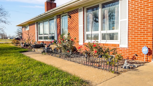 view of side of property with a yard